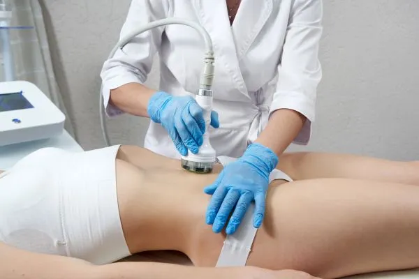 Lost the Weight but Not the Loose Skin? 2 woman having HIFU treatment on her stomach to combat loose skin South Ockendon following weight loss